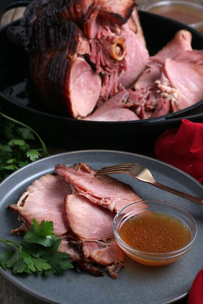 Ham sliced in iron skillet and served on gray plate