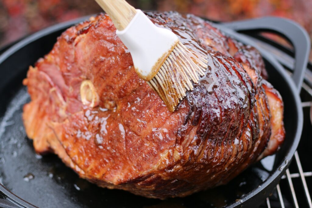 brushing glaze on smoked ham