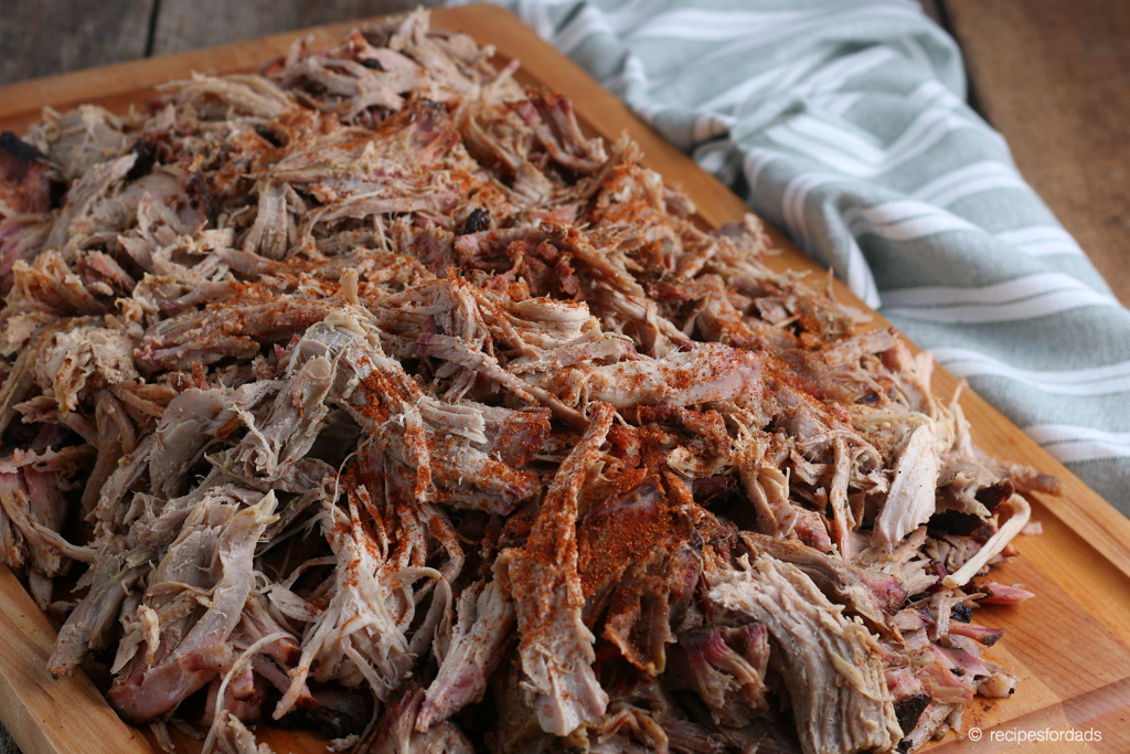 Adding some final seasoning to the shredded pork butt