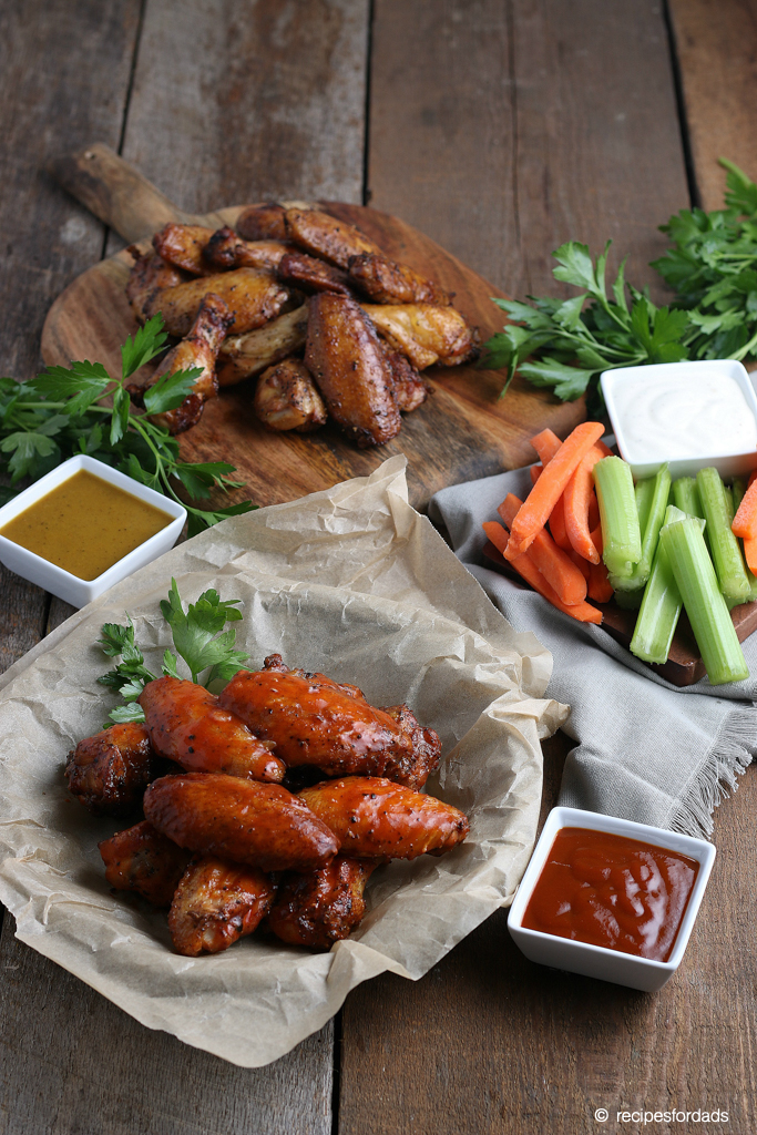 Serving smoked chicken wings with your favorite sides like carrots and celery, with dipping sauces