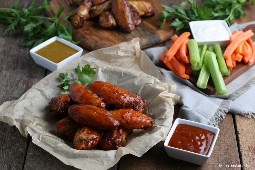 smoked hot chicken wings served with celery and carrots