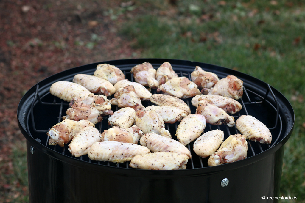 chicken wings cooking on a Weber smoker 