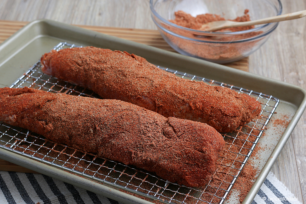 pork tenderloin covered in rub (seasoning) preparing for smoking