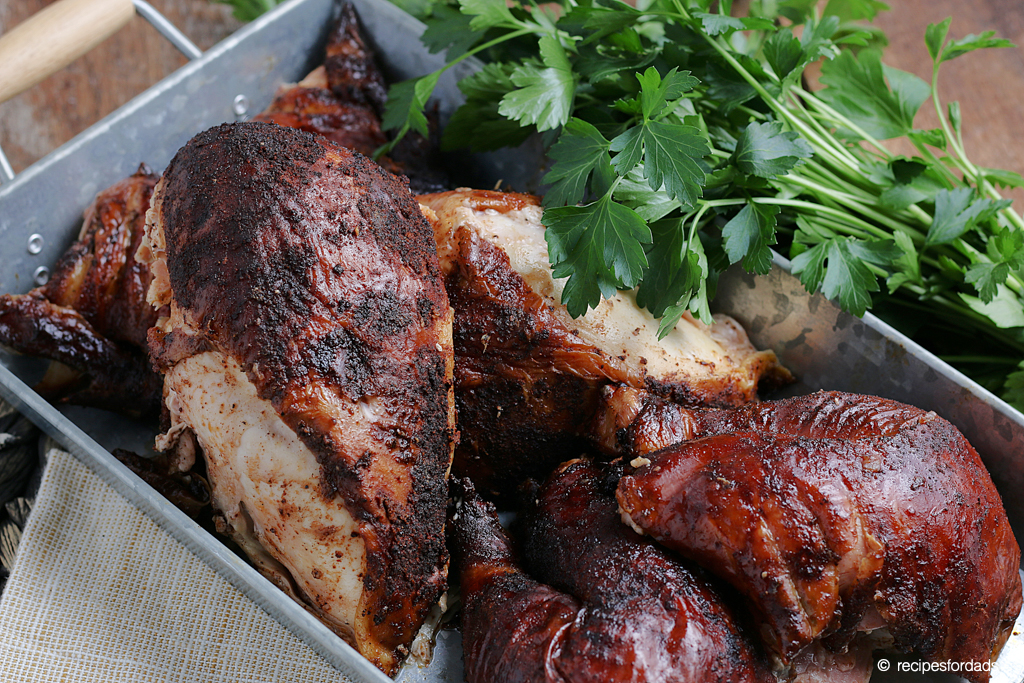 smoked whole chicken served in silver serving tray