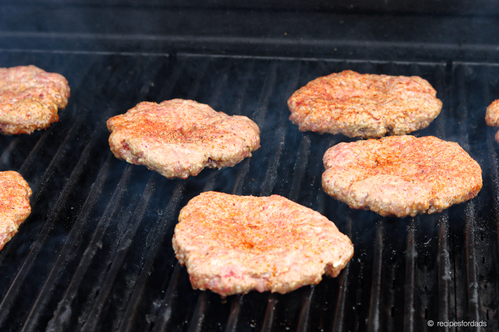 hamburgers cooking on the grill