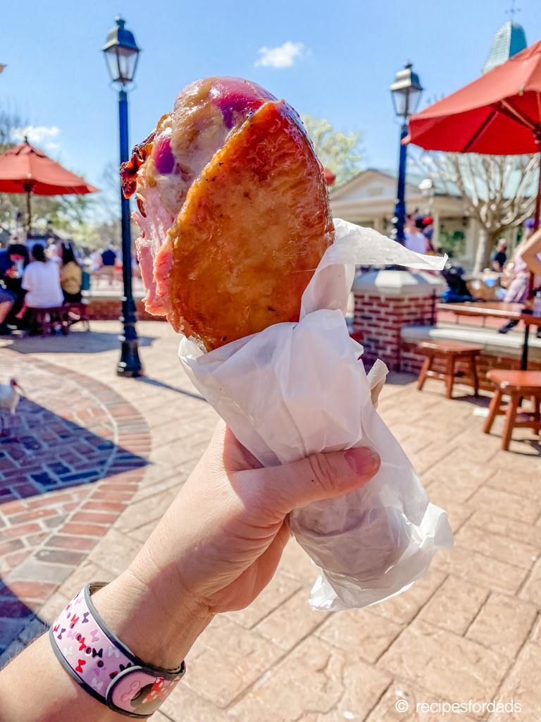 woman holding a turkey leg in Magic Kingdom 