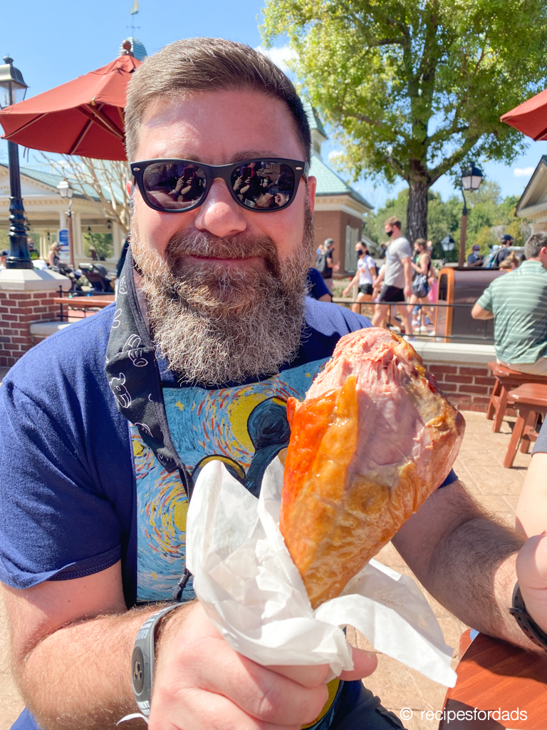 man holding a smoked turkey leg in Magic Kingdom 