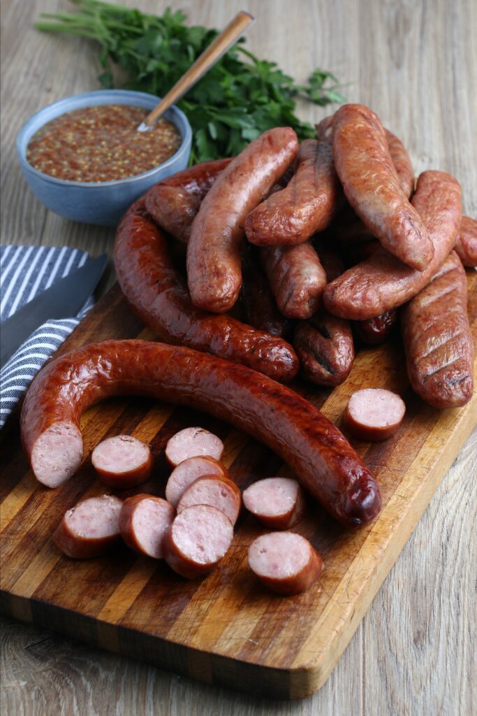 cooked smoked sausage served on cutting board