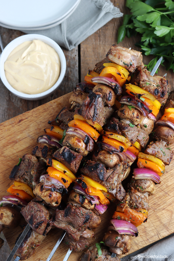 Beef kabobs with bell peppers and onions served on metal skewers