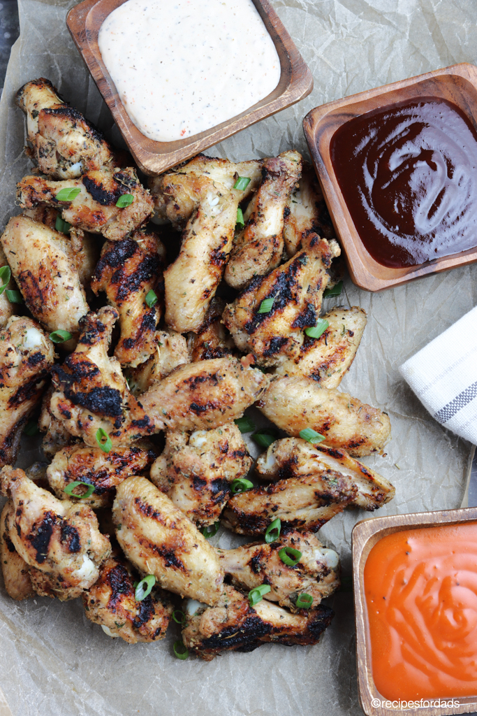 grilled chicken wings served with hot sauce and BBQ Sauce