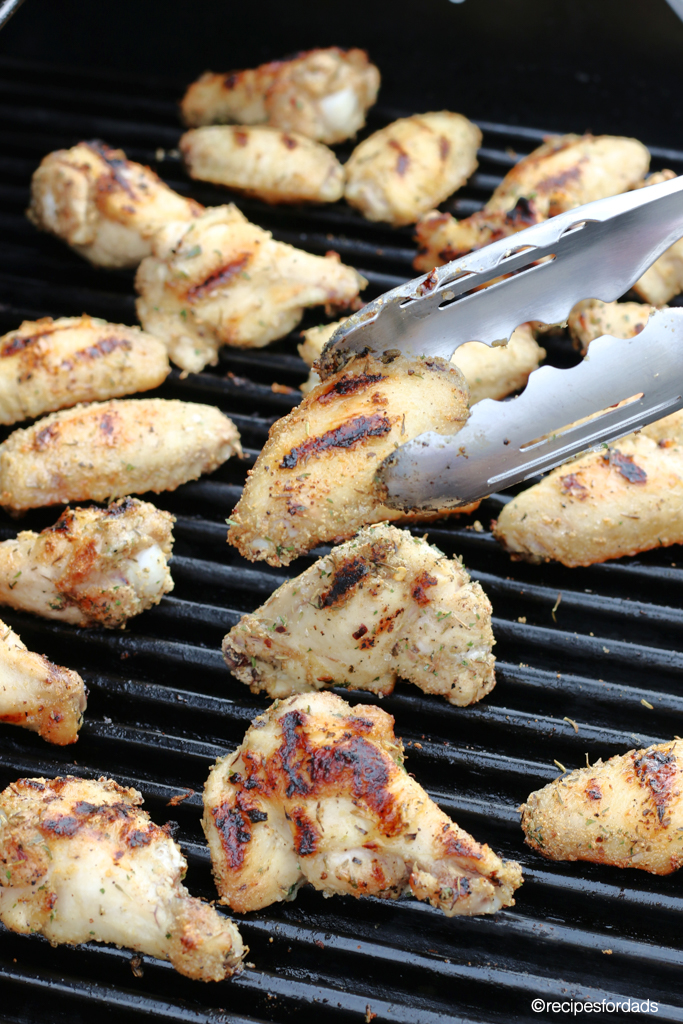 Flipping chicken wings on grill frequently