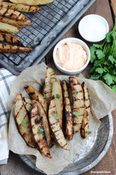 grilled potato wedges served with dipping sauce
