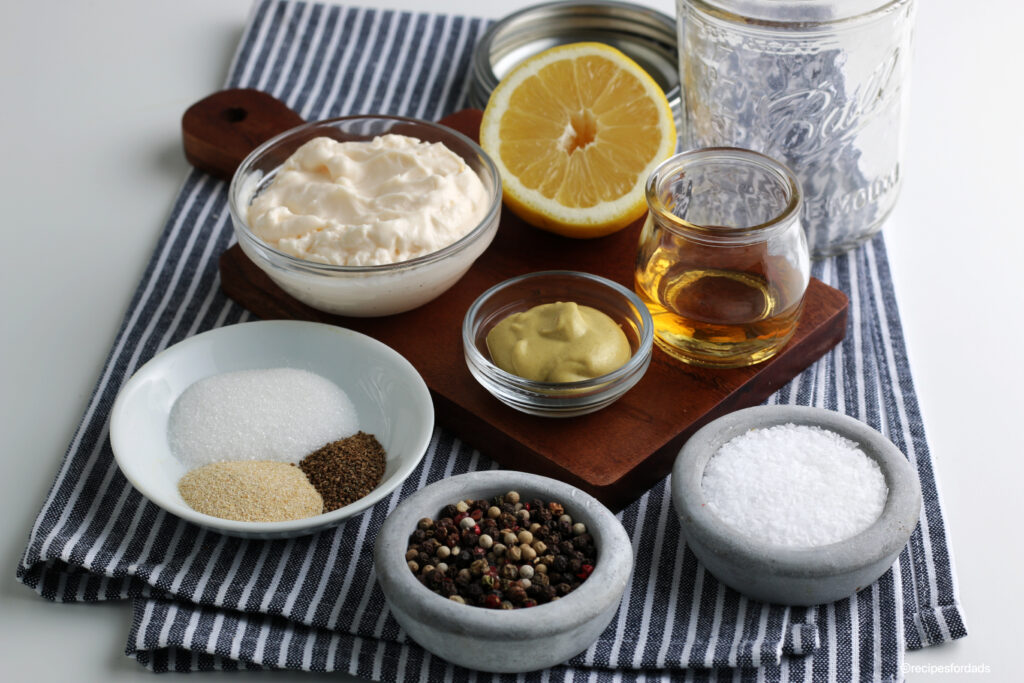 ingredients to make homemade coleslaw dressing displayed on a blue and white napkin