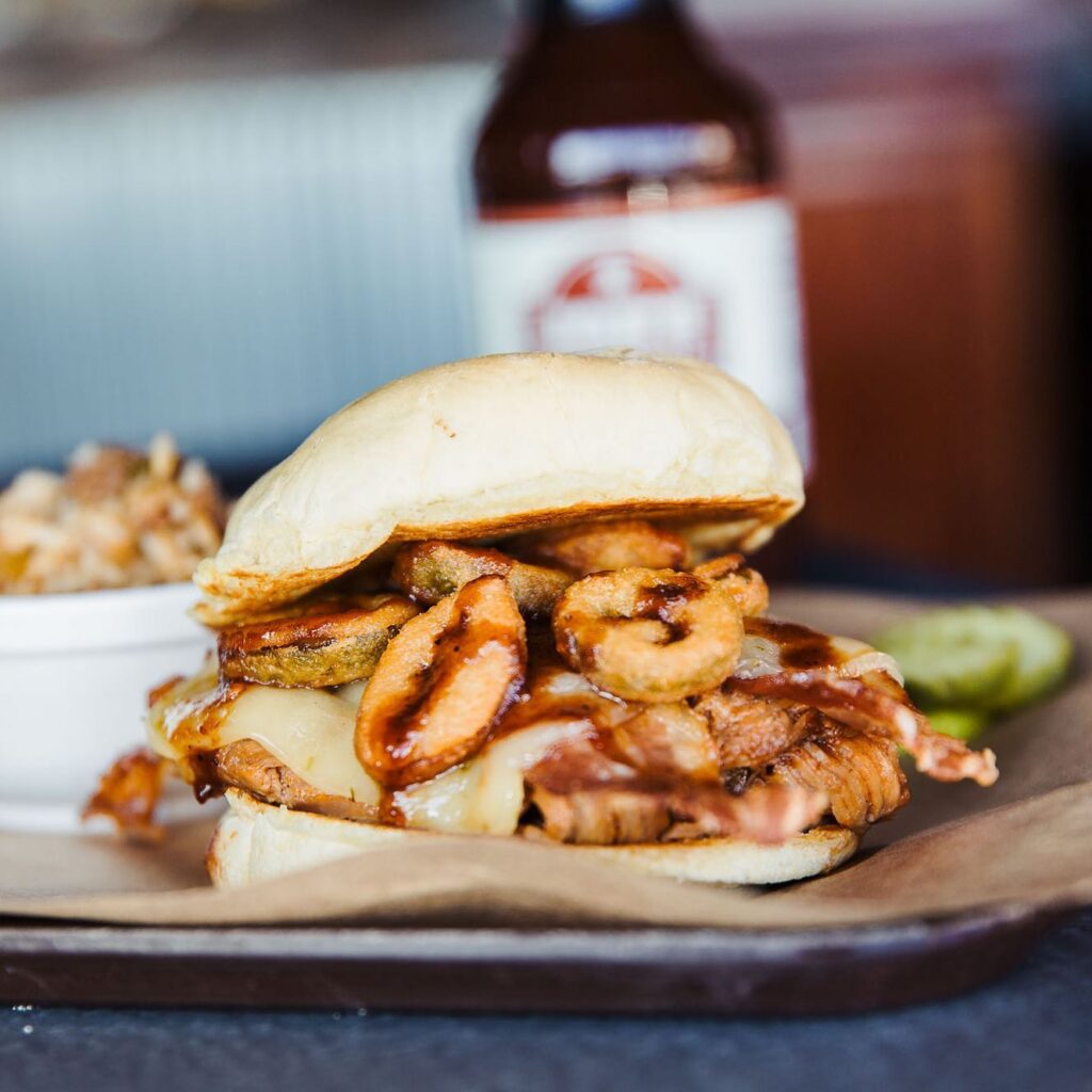 Delicious BBQ sandwich with fried pickles served at Joe's Kansas City Bar-B-Que