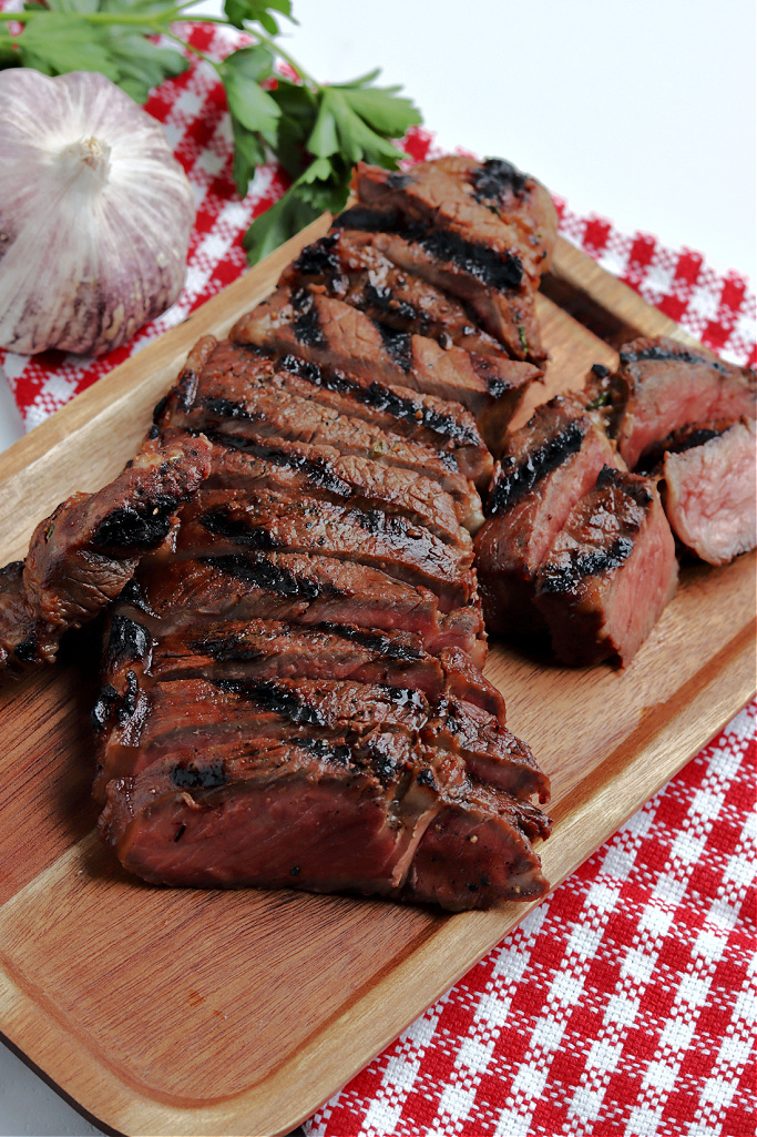 marinated steak on cutting board