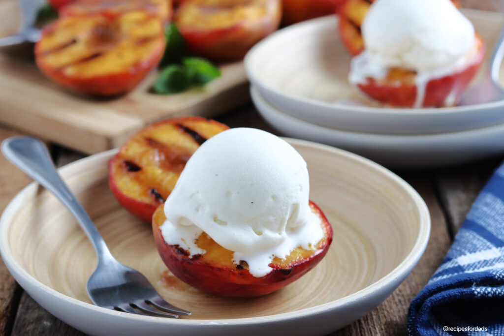 grilled peaches topped with vanilla ice cream