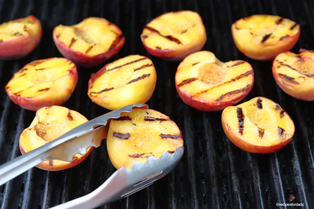 flipping peaches on the gas grill