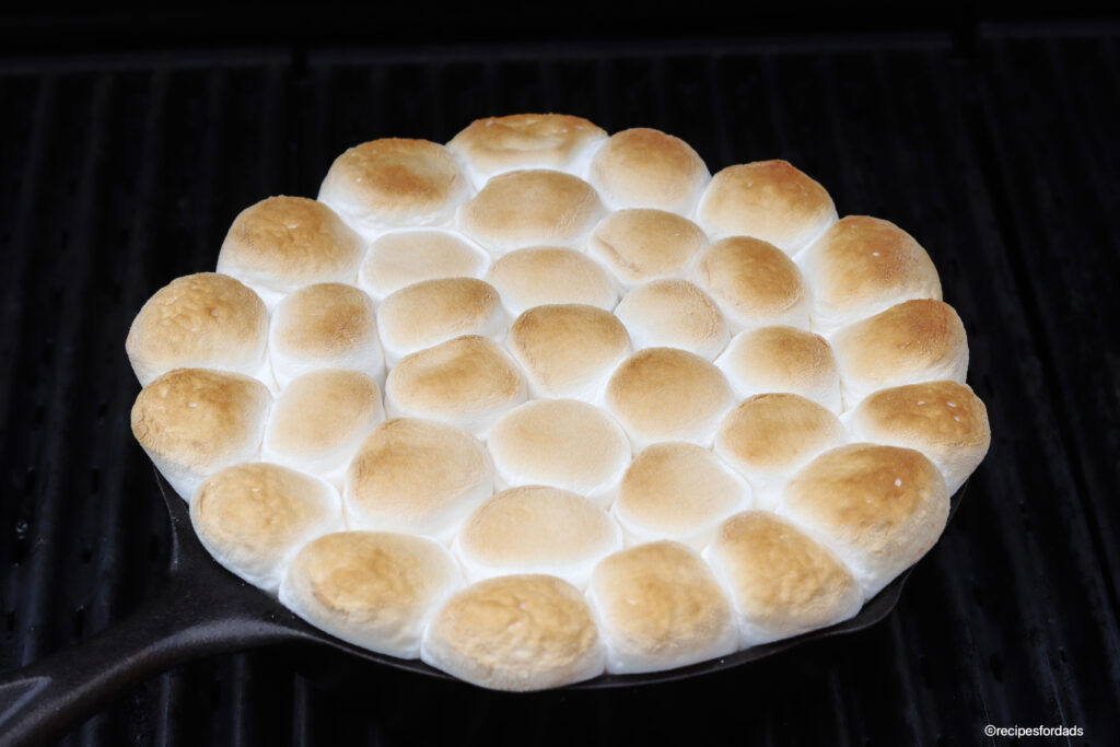 marshmallows and S'mores Dip cooking on the grill