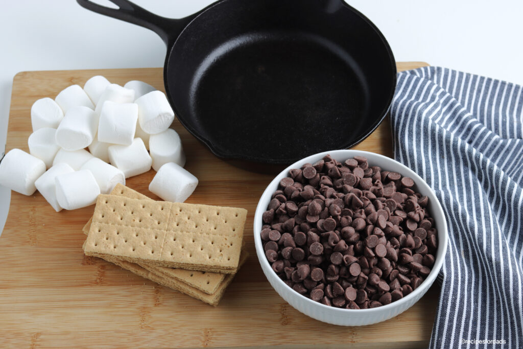 ingredients to make S'mores Dip (chocolate chips, graham crackers and marshmallows)