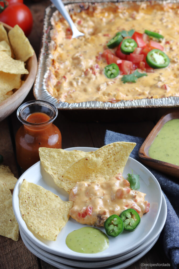 smoked queso dip served with salsa and tortilla chips