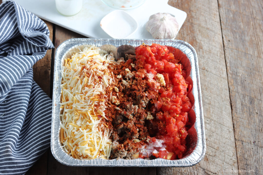 Mix smoked queso dip ingredients together in an aluminum pan