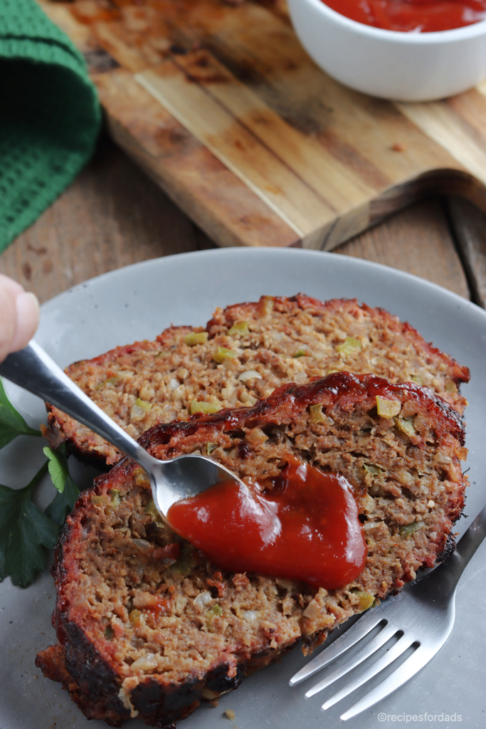 Meatloaf sliced topped with ketchup