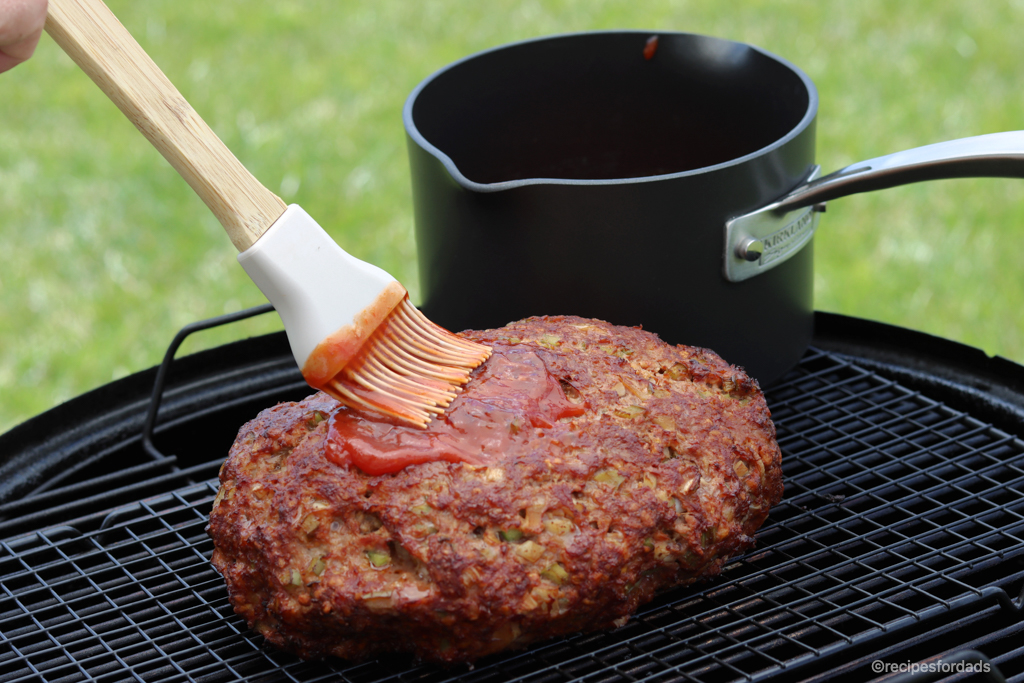 Brushing glaze on meatloaf, on smoker