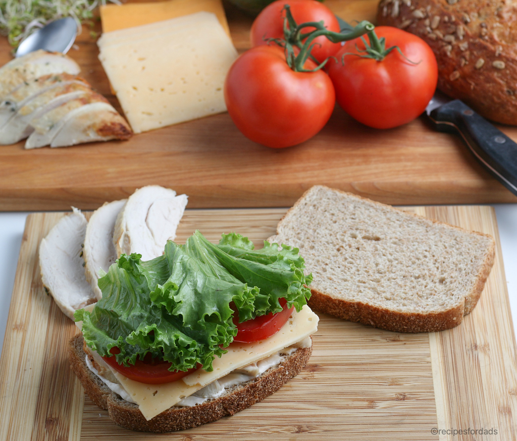 Making a Turkey Sandwich using lettuce and tomatoes