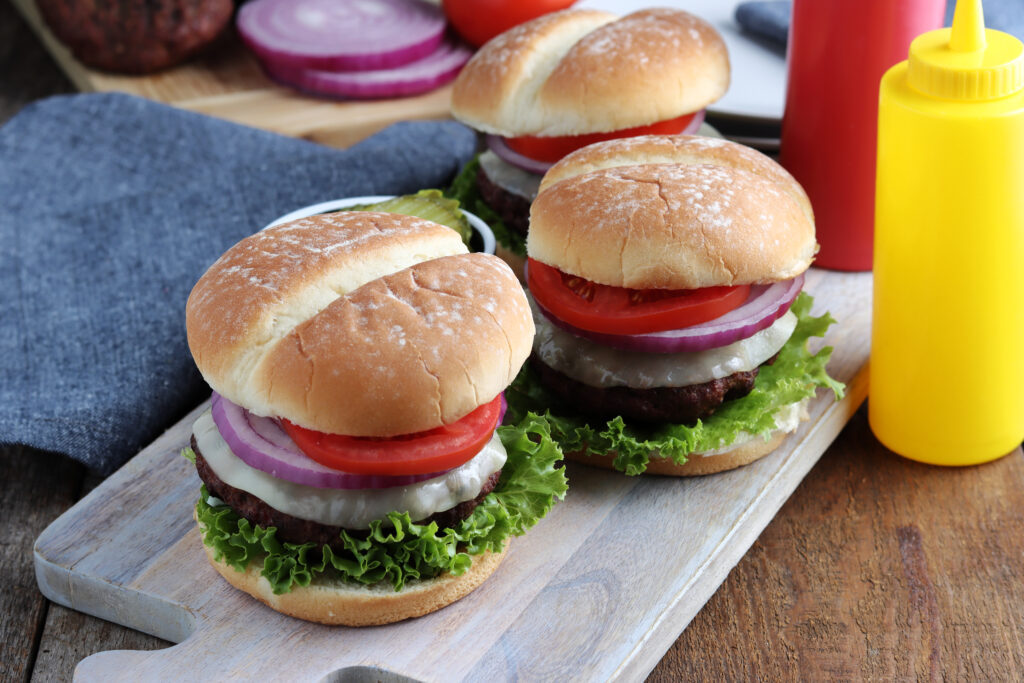 Smoked burgers served with onion, tomatoes, lettuce and cheese