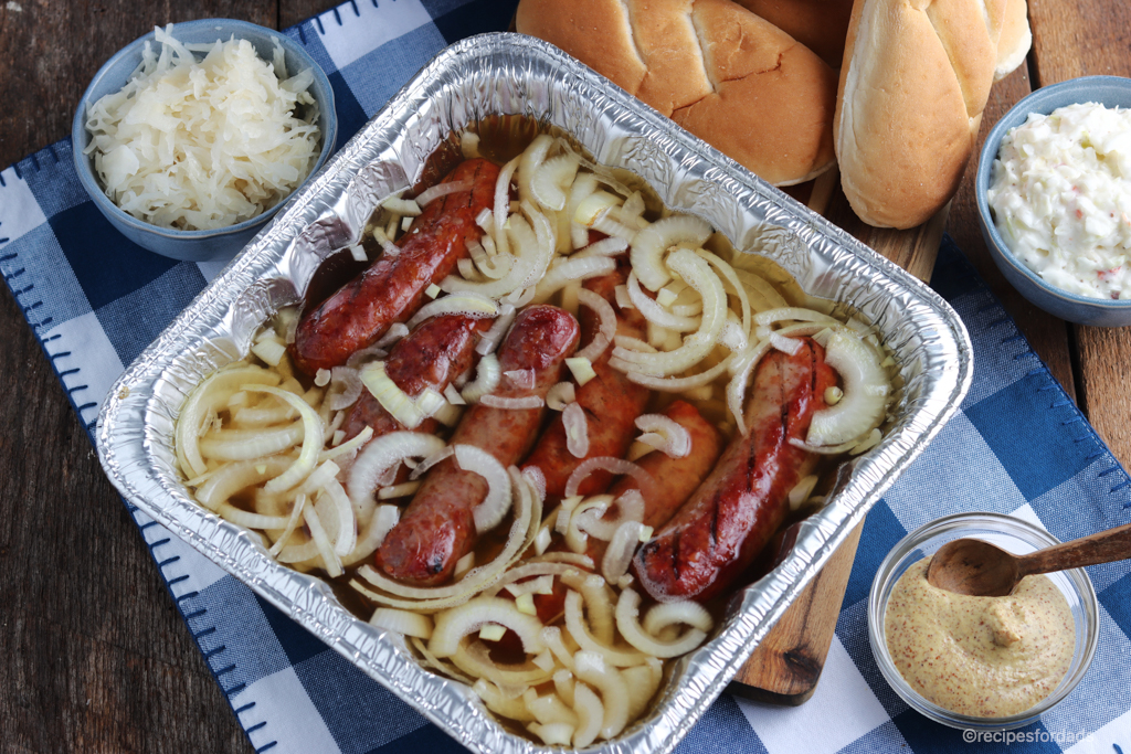 Brats in Beer and onions with condiments