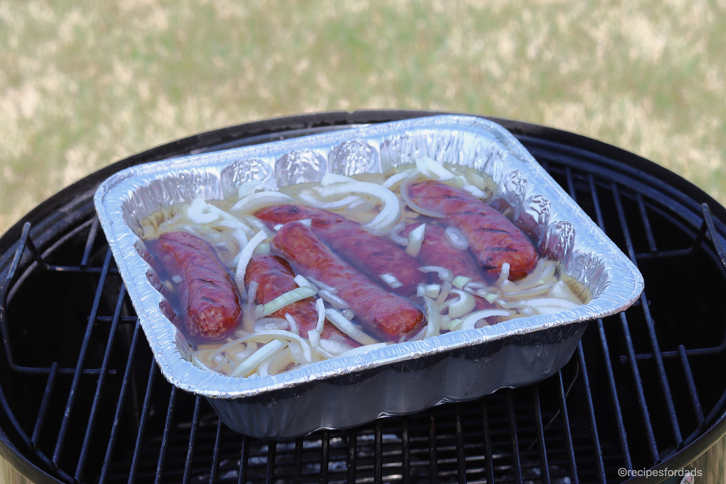 Brats in beer on smoker