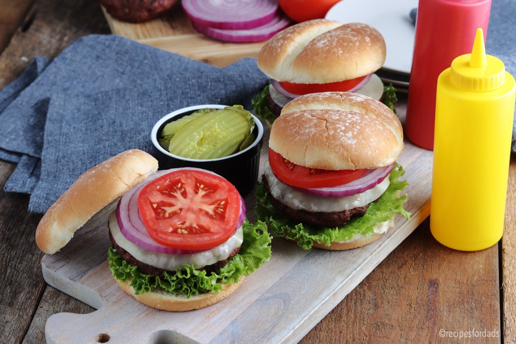 smoked burgers served with mustard, pickles and tomatoe