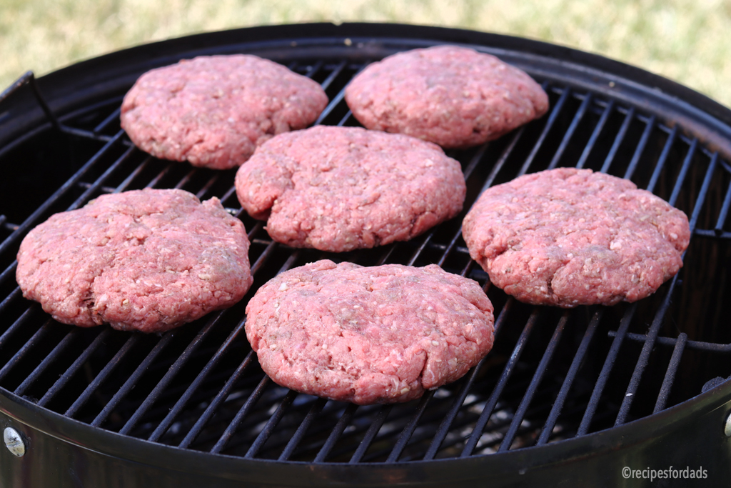 burgers cooking on a weber smoker