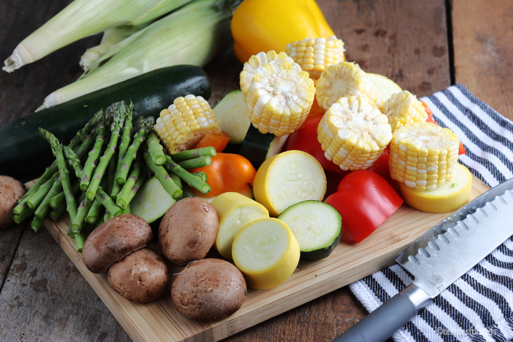 Raw Veggies have been sliced (on cutting board)