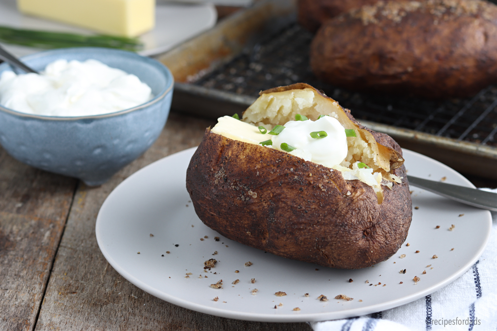 baked potato served with butter and sour cream