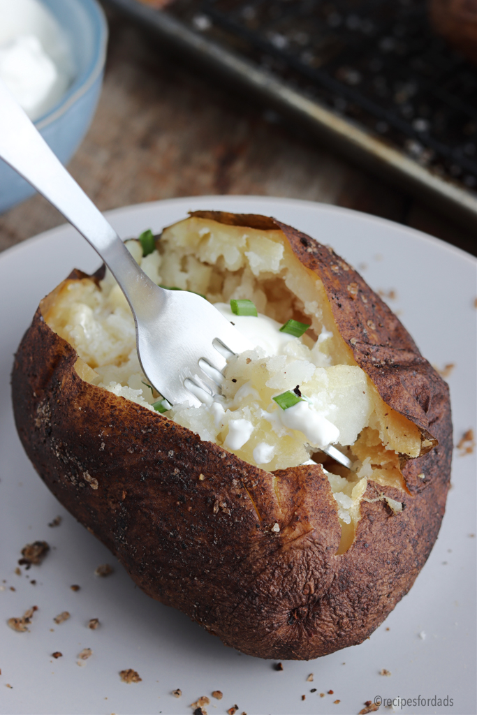 baked potato served with sour cream and chives