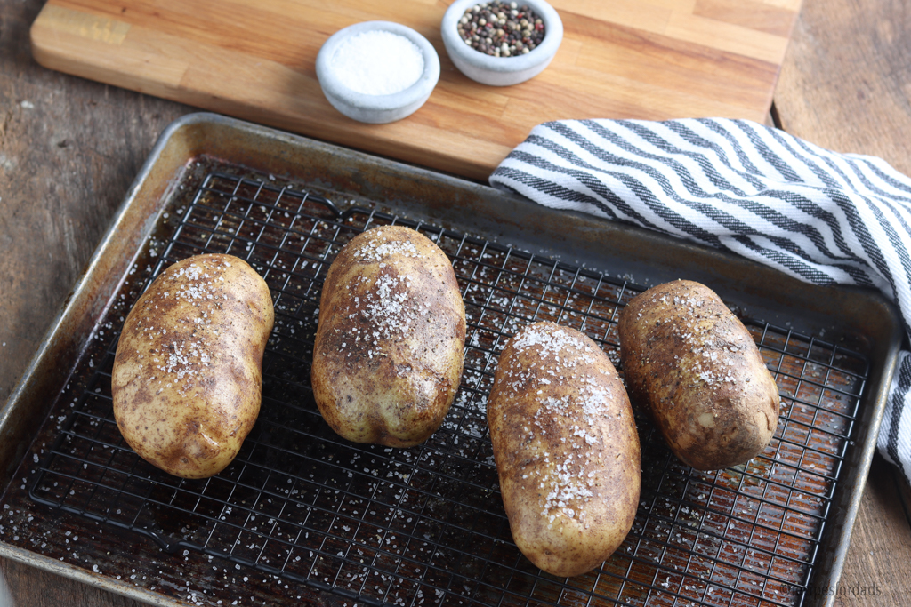 potatoes on a serving tray with pepper and salt