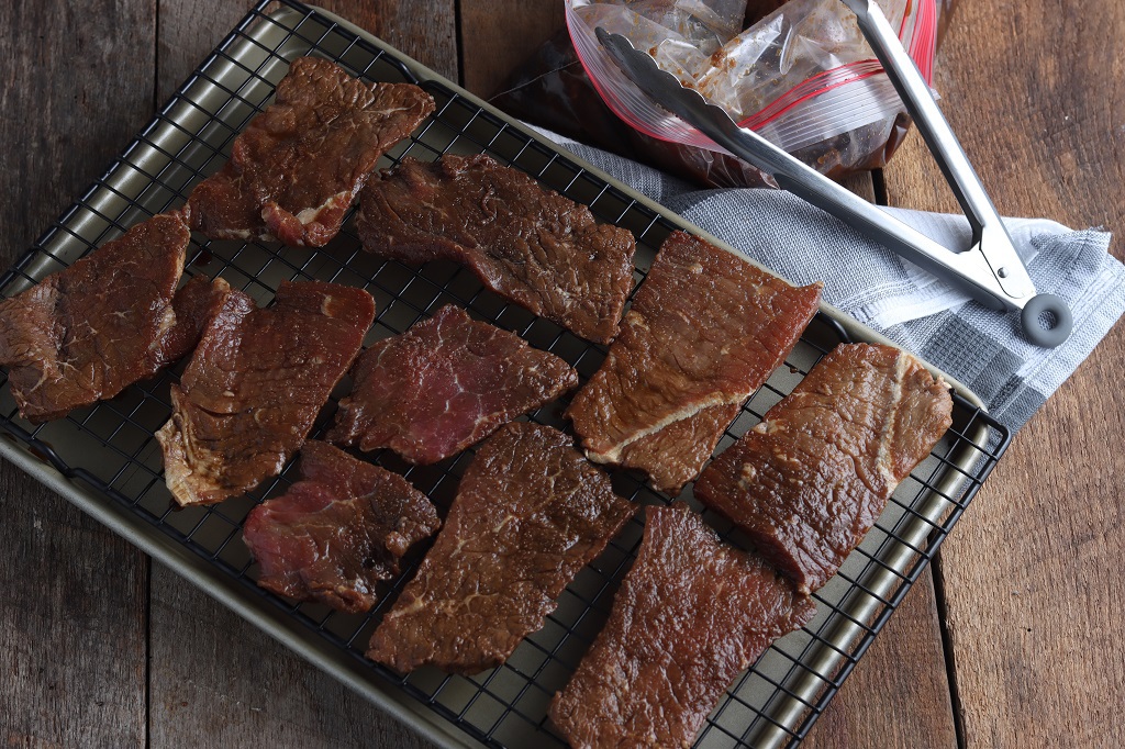 Sliced meat on baking rack.