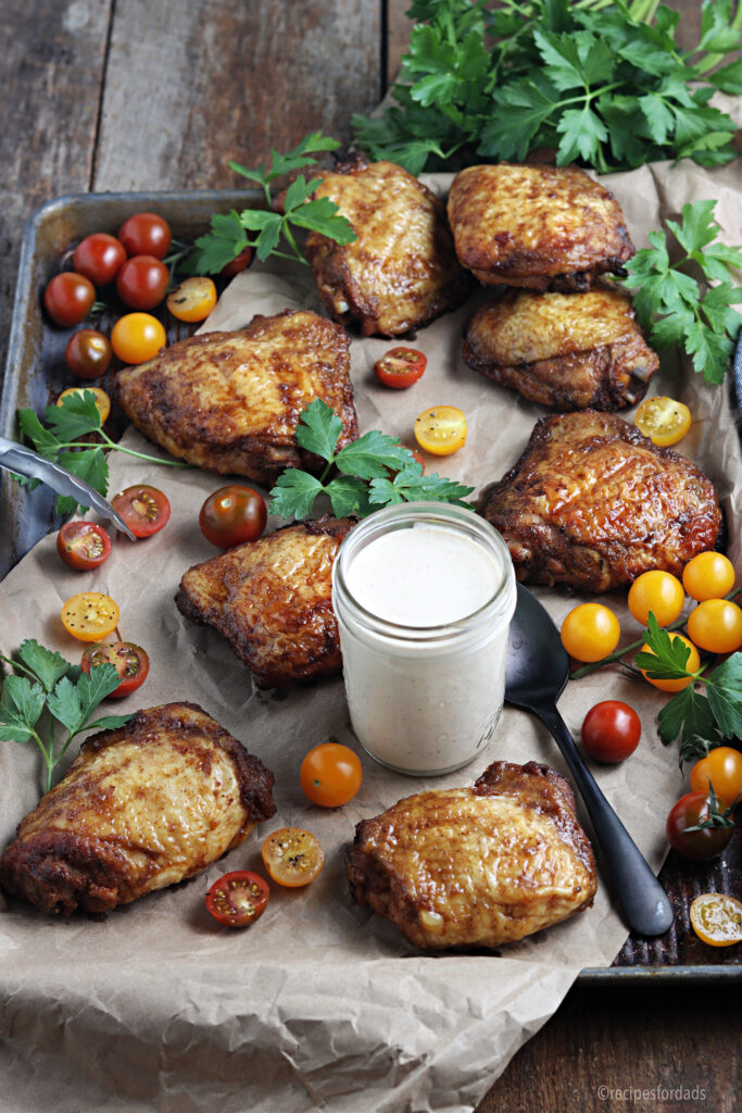 smoked chicken thighs served with alabama white sauce