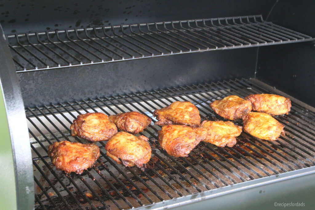 Close up shot of chicken thighs on smoker