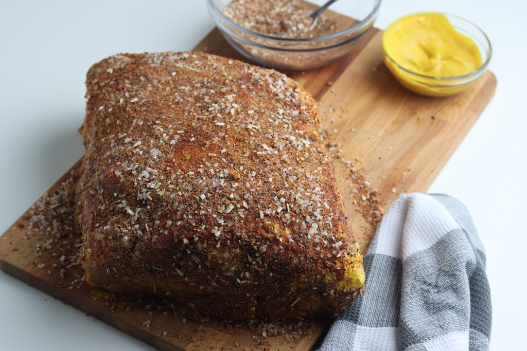 Pork butt covered in seasonings.