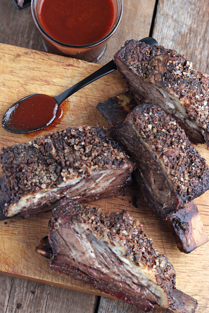 Cooked Traeger smoked beef ribs served with Texas BBQ sauce