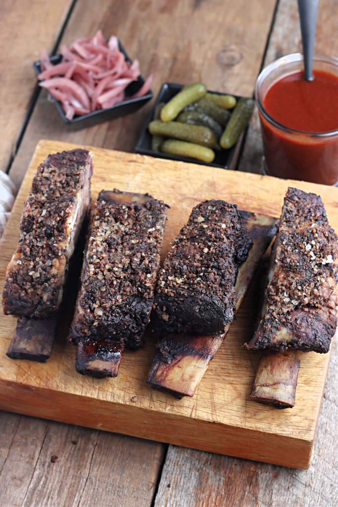 Cooked smoked beef ribs served with Texas BBQ sauce