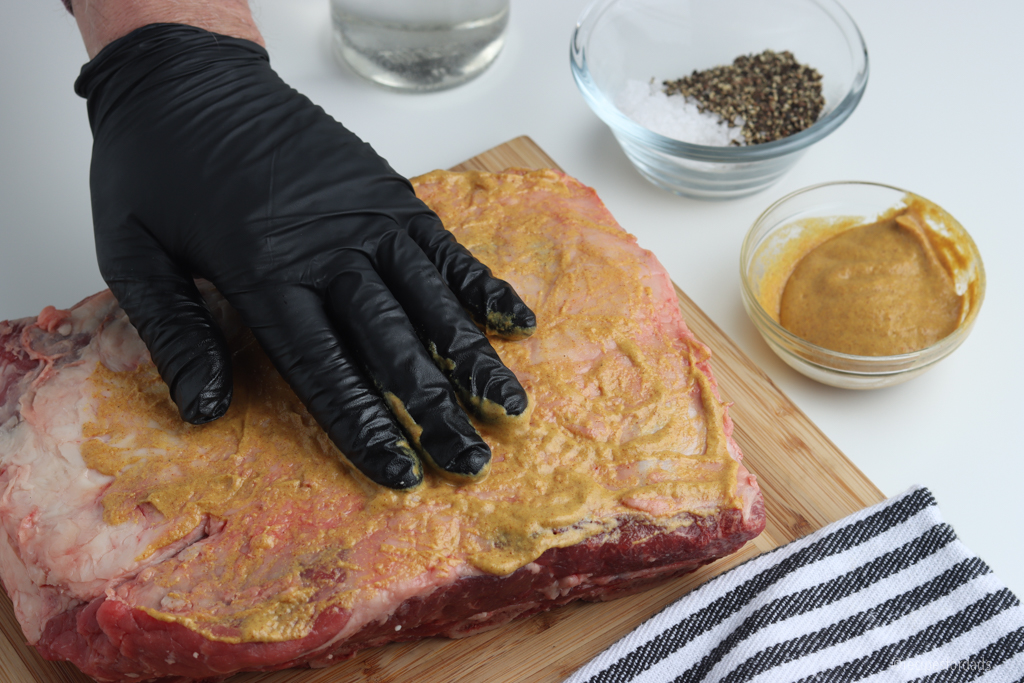 Beef ribs covered with mustard and seasonings