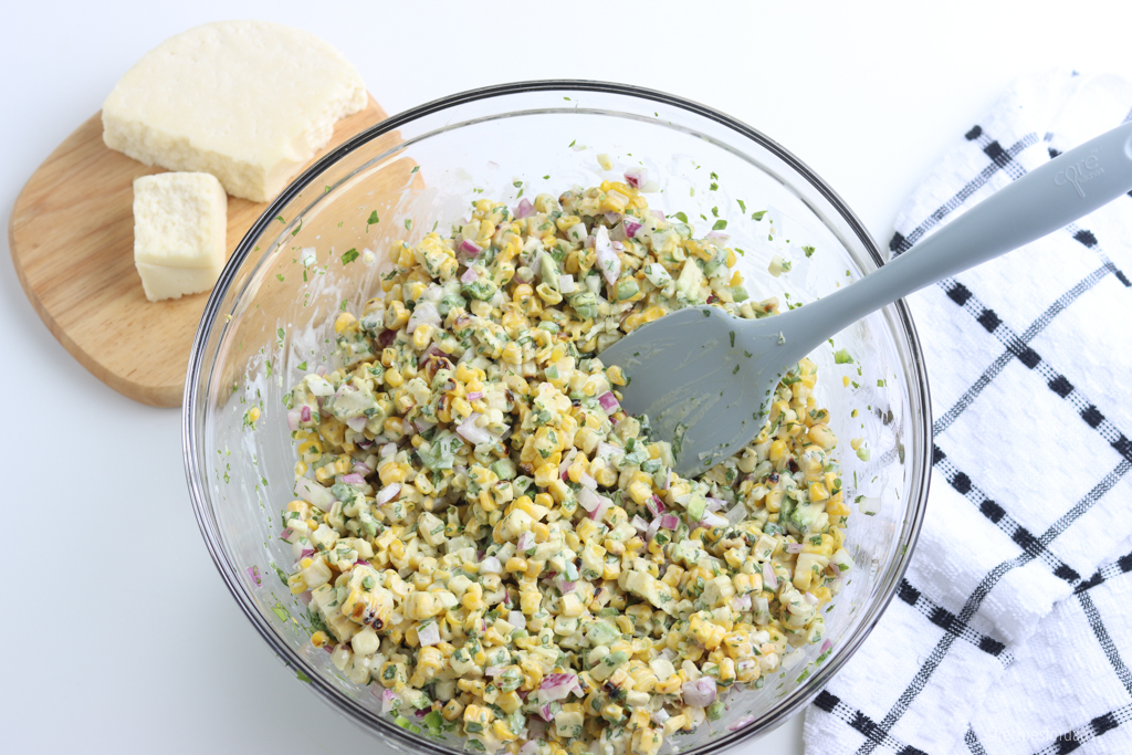 mixing the corn salad