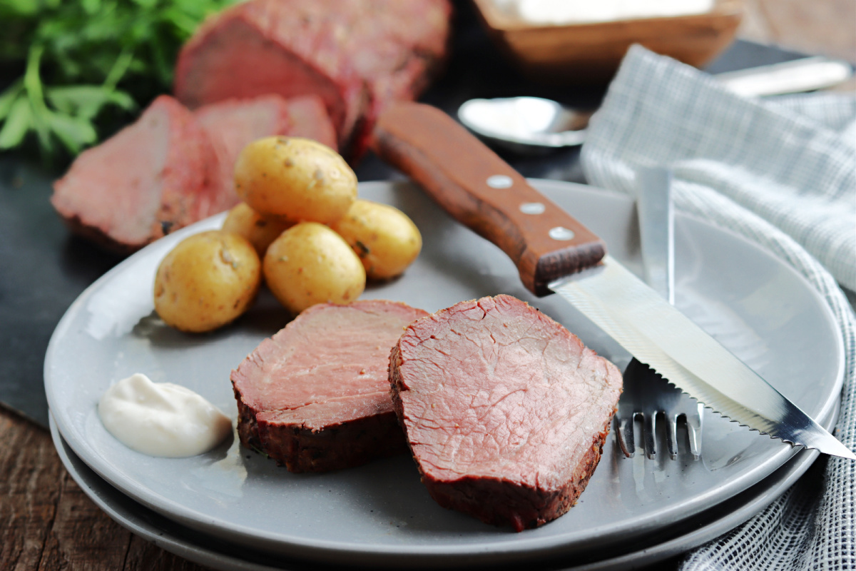 smoked beef tenderloin sliced and served on a gray plate