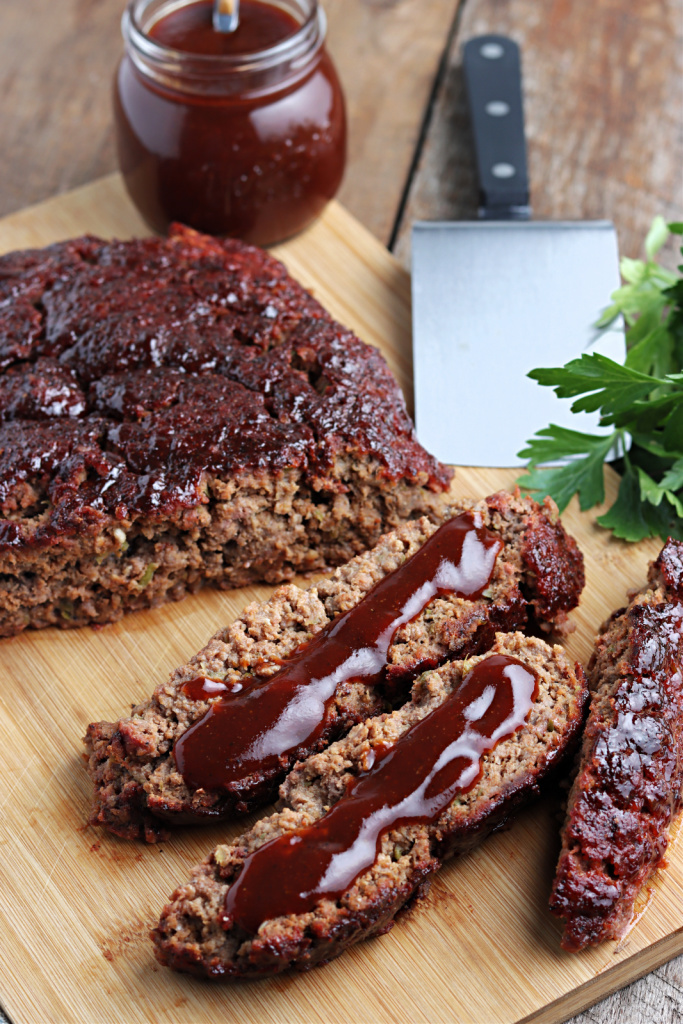 smoked meatloaf on cutting board with barbecue sauce