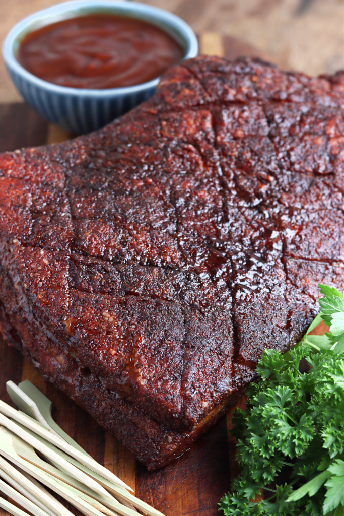 Smoked Pork Belly cut on cutting board with sauce