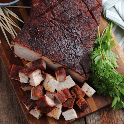 Smoked Pork Belly cut on cutting board with sauce