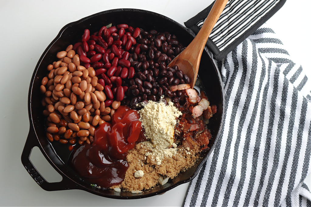 beans, sauce and seasoning in cast iron skillet